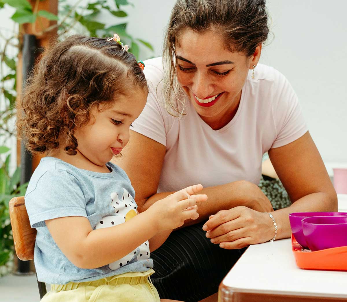 A Woman And A Child Sitting At A Table