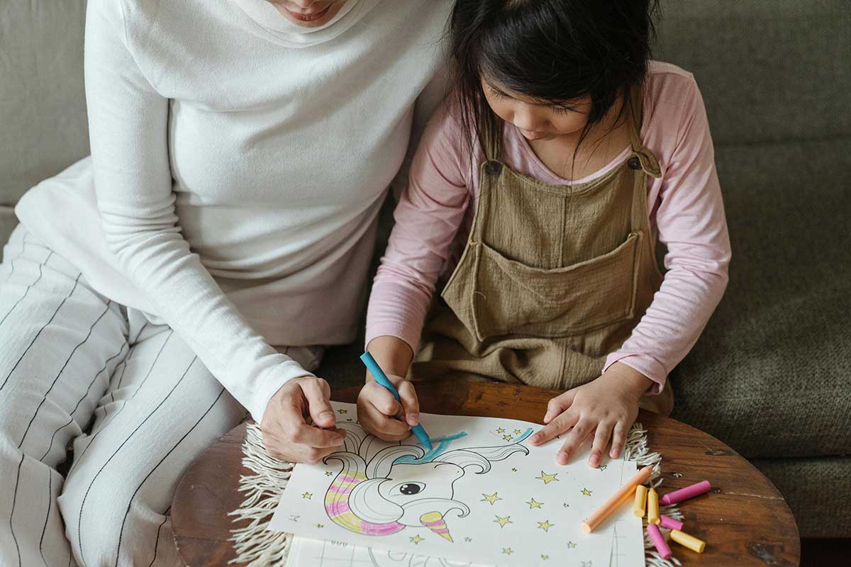 Crop Little Girl With Mother Coloring Picture Of Unicorn