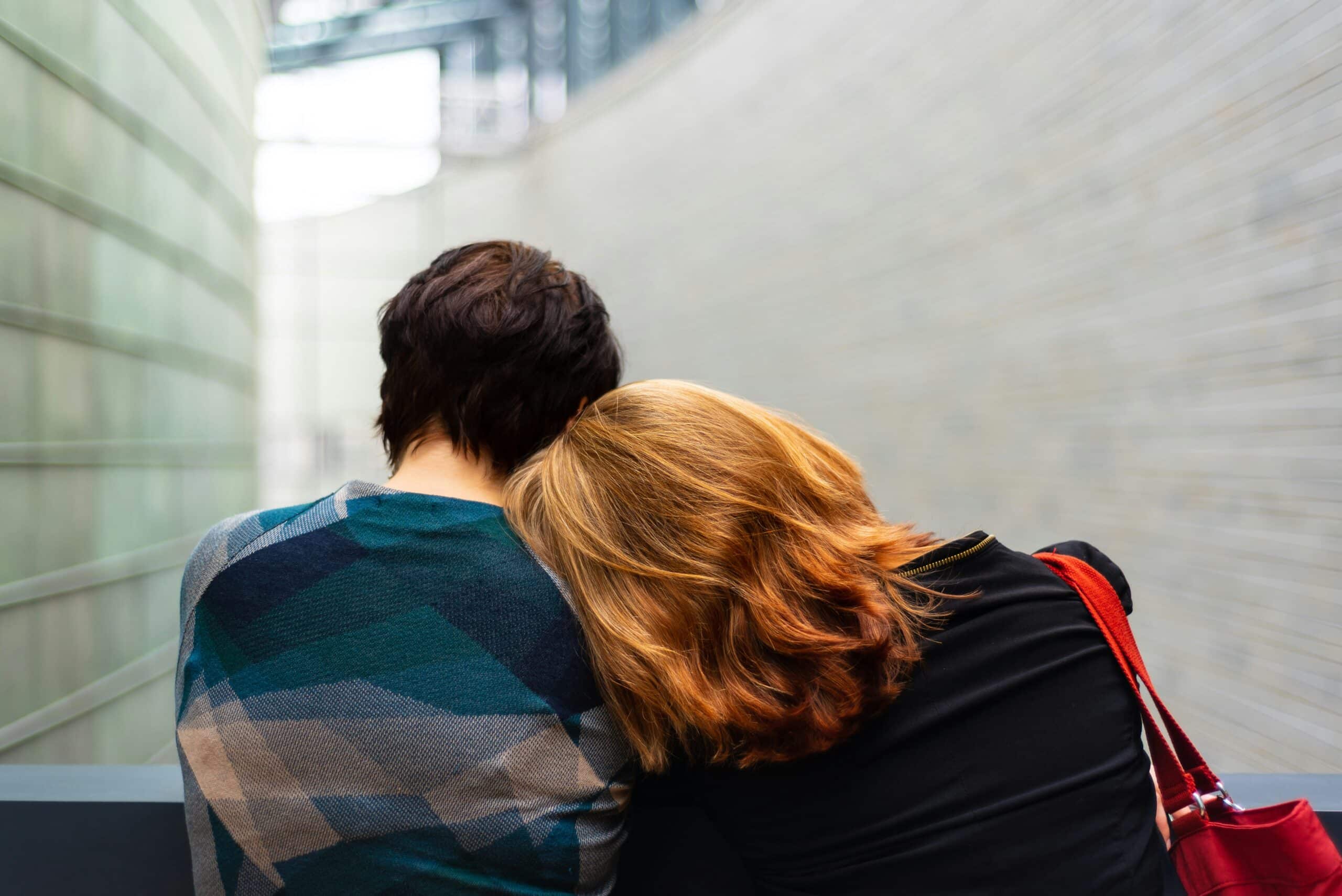 two people sit on bench